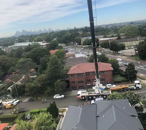 Aerial view of a crane working between apartment blocks